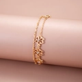Detail of gold double-layer chain bracelet featuring hollow flowers and sparkling crystals - KC Gold Double Layer Hollow Floral Style (DZ-196)