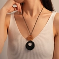 Vintage bohemian necklace featuring marble resin ball and black circular ring on cord - Brown Black Resin Circle Style