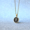 Minimalist gold necklace with a round black enamel pendant featuring a gold letter Y - Letter Y