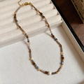 Close-up of tiger eye shell beaded necklace with gold lobster clasp and extension chain - 65# Necklace - Gold - Gray