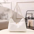 Chic off-white quilted hobo shoulder bag with gold zippers in minimalist home setting - White