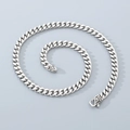 Macro detail of 8mm silver Cuban chain with vintage textured lobster clasp and flat links - Patterned Clasp / 45cm