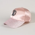 Detail of pink satin baseball cap with sequined brim and decorative letter D patch - Style 30-Pink Satin Sequin CENICEN D