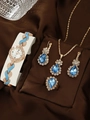 Golden alloy jewelry set with blue teardrop stones and white quartz watch on silk - Blue Set