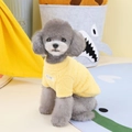 Close-up of yellow fleece dog sweater showing soft plush texture on a grey poodle - Yellow