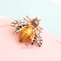 Exquisite gold-tone bee brooch with intricate black patterned wings and textured body - Gold