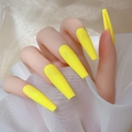 Close-up of matte lemon yellow long coffin press-on nails worn on hand with tulle background - Bright Yellow-Glossy(CBL-27)