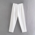 Detail of white trousers featuring a unique V-cut high waistband and pleated design - XS / Off White