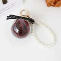 Preserved red rose keychain in acrylic ball with pearl bracelet and golden clasp - Burgundy