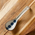 Japanese style ceramic soup spoon with blue floral pattern on a rustic wooden tray - Small Blue Buds