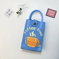 Detail of light blue knitted mini bag with coffee time pattern and metal button closure - Coffee Blue