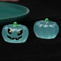 Macro shot of luminous blue translucent pumpkin figurines for Halloween DIY decor - Luminous-Squint-Blue Pumpkin Black Eyes