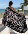 Close-up of decorative paisley patterns on a black beach shawl during a sunny resort vacation - Black Base Beige Swirl (Retro Scrolling Grass-12)