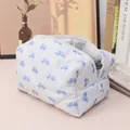 Quilted floral makeup bag featuring a blue bow pattern and white zipper closure - Blue Bowknot