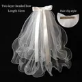 Detail of double-layer white bridal veil with pearls, silk bow, and a metal hair clip - Double Layer Ruffled Bow Pearl Hair Clip (55CM)
