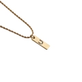 Macro shot of a gold-toned necklace featuring a rectangular pendant with a zircon letter U - Letter U + 60CM Twist Chain