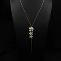 Long gold necklace with natural pearls and flower pendant on black jewelry display - Three Flowers Pendant Sweater Chain