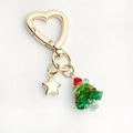 Portachiavi a cuore dorato con albero di Natale di perline e ciondolo a stella su sfondo bianco - Albero di Natale Gancio Cuore Oro