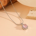 Macro detail of pink octagon crystal pendant with silver snake chain on a natural background - Silver Pink Zirconia Necklace