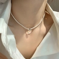 Elegant freshwater pearl bracelet with a shimmering heart charm and gold-plated details - Heart Shell Pearl Necklace