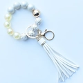 Close-up of leopard silicone beads and white PU tassel keychain with golden metal ring - Premium White
