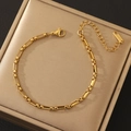 Detailed macro view of gold stainless steel link chain with lobster clasp and tag - 18K Gold Bamboo Link Bracelet (10832)