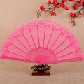 Elegant pink lace folding fan with gold floral patterns on a vintage wooden stand - Rose Red
