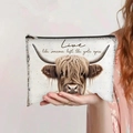 Detail view of Highland Cow printed makeup bag held by hand to show size and canvas texture - Live Like Someone Left The Gate Open Highland Cow (jiayingpbb0117)