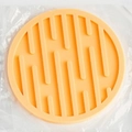 Thick round orange silicone coaster with anti-slip texture in transparent packaging - Drain Style / Yellow