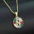 Gold plated letter N necklace with rainbow cubic zirconia stones on dark background - Gold Plated Rainbow Zirconia Letter N