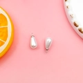 Close-up of teardrop pearl pendants with silver metal loops for DIY jewelry making - 6x10mm / White K/Silver