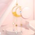 Close-up of golden moon suncatcher featuring yellow crystal stones and metal sun charms - Citrine Style