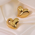 Elegant gold heart-shaped stud earrings in polished stainless steel on silk fabric - Gold