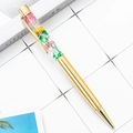 Penna a sfera in metallo dorato con eleganti fiori secchi rosa e verdi all'interno - Oro placcato