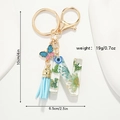 Detail of resin letter N keychain with dried flowers, blue butterfly, and tassel dimensions - Letter N