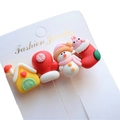Macro view of Christmas resin hair clips featuring snowman and reindeer on a white card - Style 5 Christmas Hair Clip