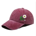 Close-up of floral daisy embroidery on vintage washed burgundy cotton baseball cap - One Size / Burgundy