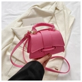 Detailed macro of pink lychee texture PU leather handbag with elegant handle and strap - Pink
