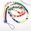 Detailed view of colorful phone charm with evil eye, smiley, and acrylic flower beads - Rainbow Soft Ceramic Beaded