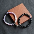 Detailed view of couple magnetic bracelets with purple stone and black matte beads on wood - Matte Stone + Purple Weathered