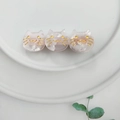 Macro view of three pink cat hair clips with pearlescent acetate texture on a plate - Transparent Pink