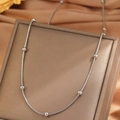 Polished silver stainless steel bead necklace displayed on a luxury jewelry box - Bead Snake Chain / Silver
