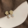 Macro shot of gold floral studs with brushed texture and natural baroque pearl drops - Style 14