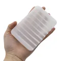 Translucent white silicone soap dish with non-slip drainage ridges in handheld view - Square / Translucent