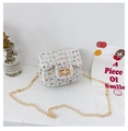 Detail of tweed crossbody bag with gold twist lock and metal chain on white surface - White