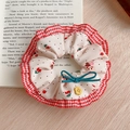 Floral scrunchie with red cherry print and blue bow on a vintage book background - Red Plaid Bow