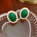 Macro shot of vintage emerald green and white enamel stud earrings in a heart glass tray - Green Oval Style (26#)