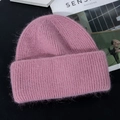 Detail of pink knitted rabbit fur winter hat with soft plush texture on black surface - M (56-58cm) / Dusty Pink