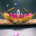 Detail of colorful crystal crown with golden wings on a decorative wooden stand - Rose Yellow Green + Gold Wings