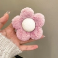 Close-up of a soft plush pink flower hair claw clip with a white fluffy center - Pink